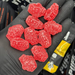 Puff LA Edibles 1000mg THC Cluster Gummies packaging display showing Strawberry Blueberry and Grape flavors