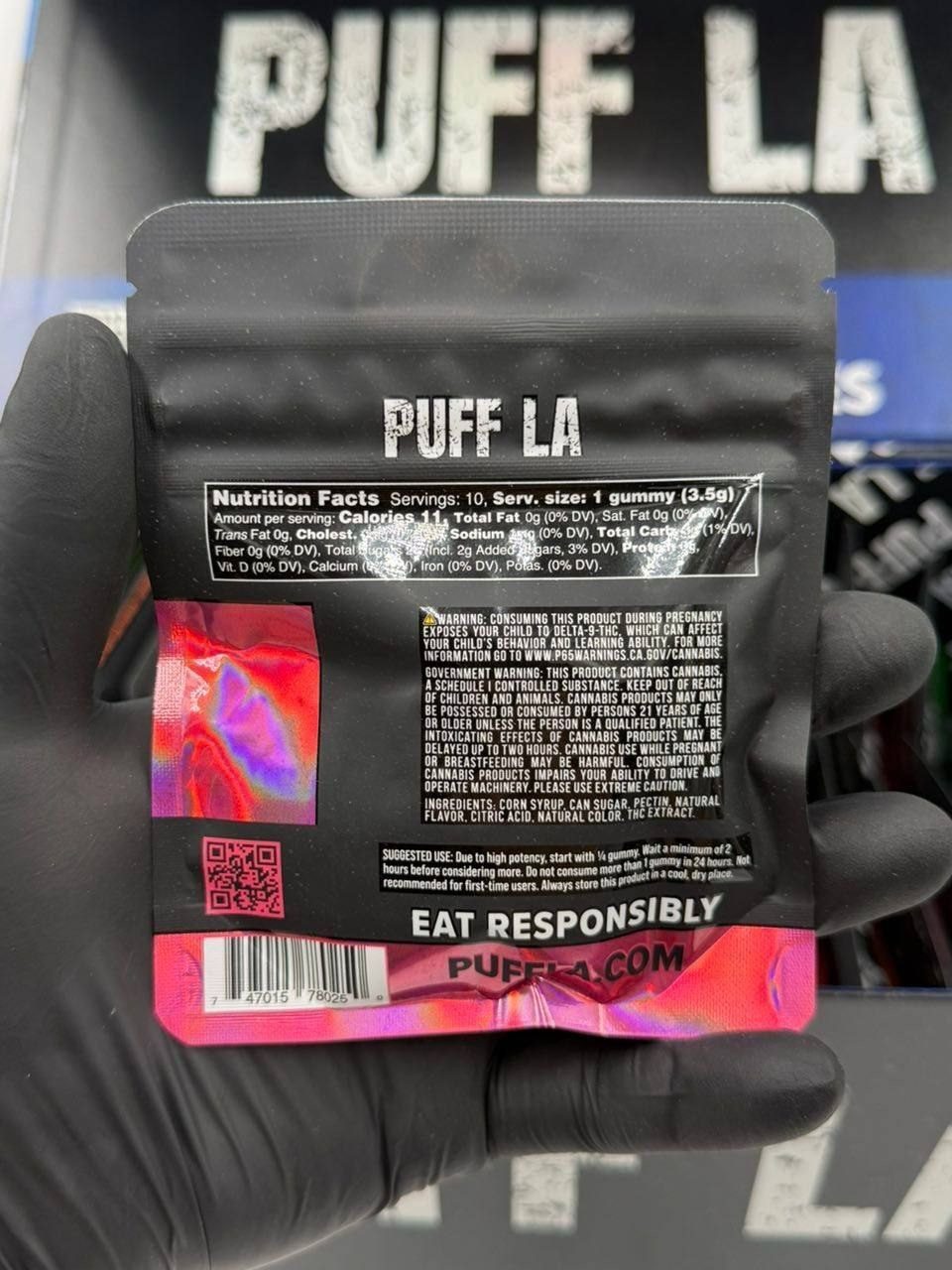 Puff LA Edibles 1000mg THC Cluster Gummies packaging display showing Strawberry Blueberry and Grape flavors