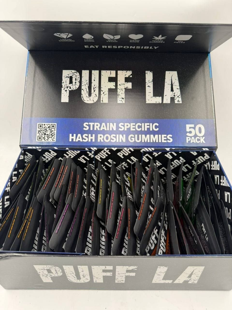 Puff LA Edibles 1000mg THC Cluster Gummies packaging display showing Strawberry Blueberry and Grape flavors