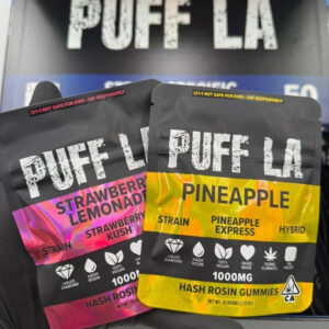 Puff LA Edibles 1000mg THC Cluster Gummies packaging display showing Strawberry Blueberry and Grape flavors