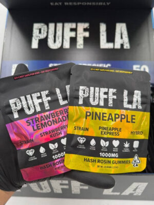 Puff LA Edibles 1000mg THC Cluster Gummies packaging display showing Strawberry Blueberry and Grape flavors