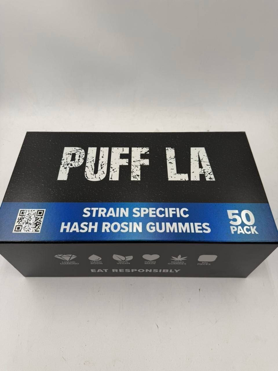 Puff LA Edibles 1000mg THC Cluster Gummies packaging display showing Strawberry Blueberry and Grape flavors